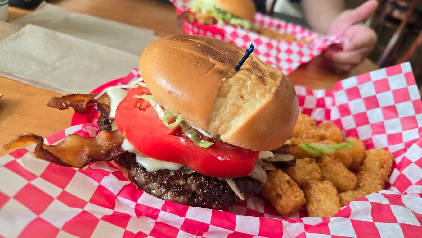 Bacon cheeseburger with tater tots in red and white checkered basket at Centreville Luncheonette