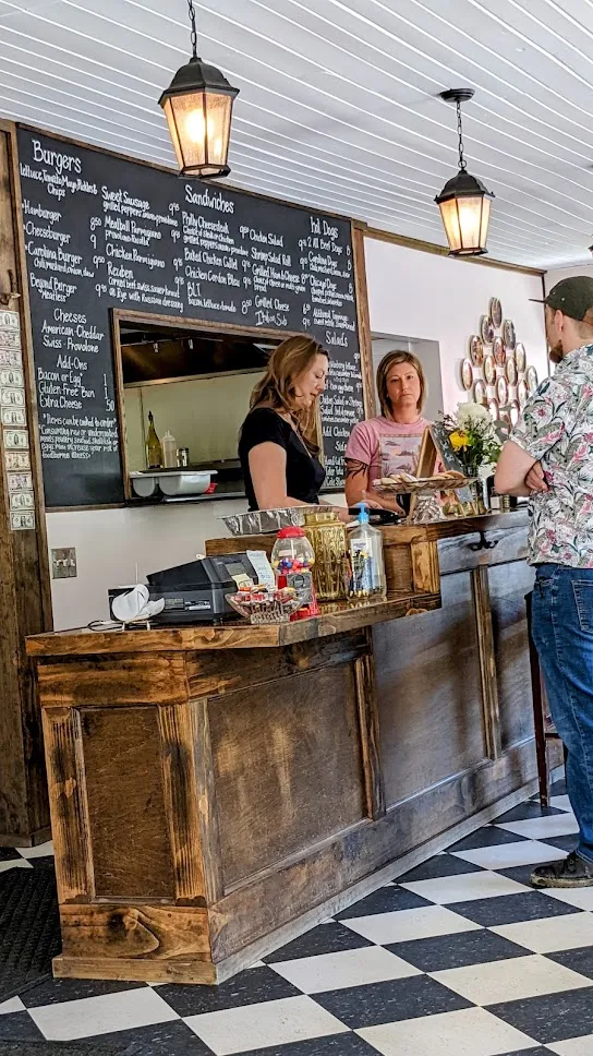 Staff at the order counter with chalkboard menu at Centreville Luncheonette