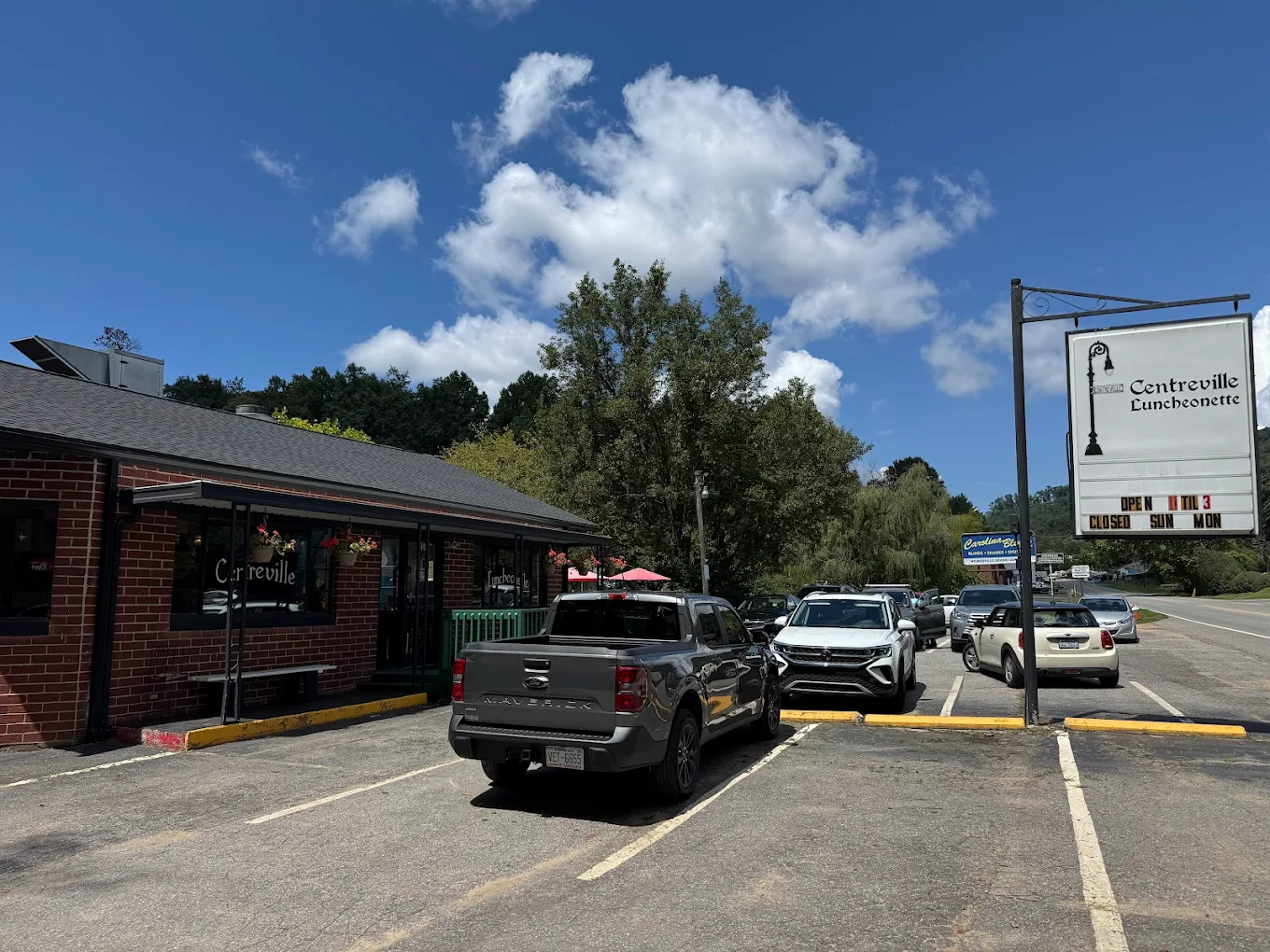 Exterior parking lot view of Centreville Luncheonette with the roadside sign on a sunny day